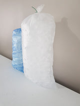 5kg Party Ice Bag leaning against wall next to a 3kg Party Ice Bag.